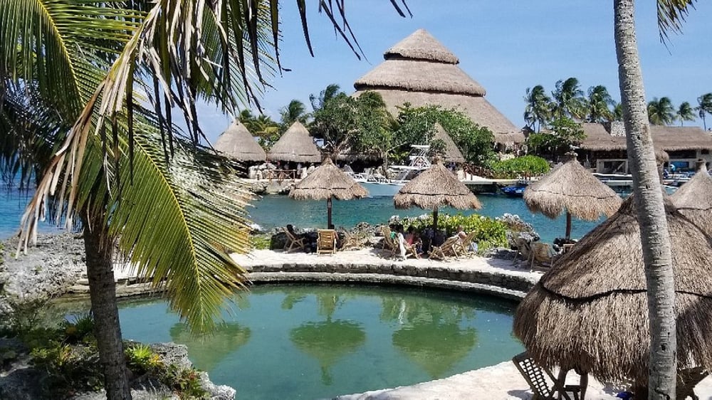 Xcaret Adventure Awaits - Lagoon and Umbrellas