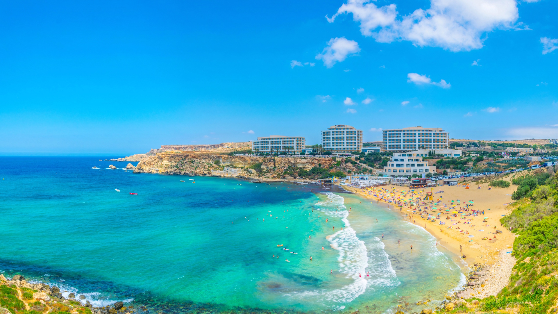 Families enjoying the Golden Bay Beach in Malta